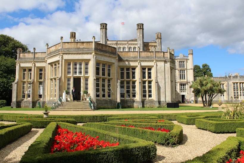 A grand stone house with formal gardens